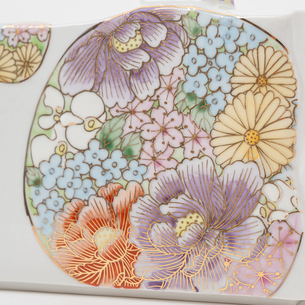 Close-up of a hand-painted Kutani Ware vase from Taishi Kiln, showing intricate floral patterns and gold accents.