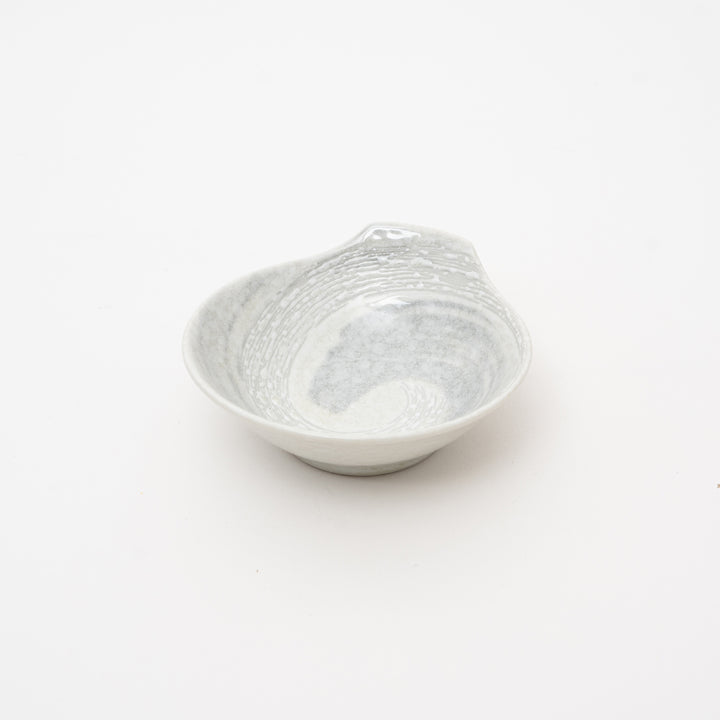 Japanese Hakusetsu white porcelain bowl with small handle showing minimalist design and traditional craftsmanship