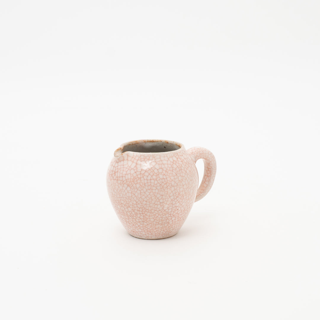 Zohogama Aka (Red) Kannyu mini creamer with a distinctive pink cracked glaze and handle, showcasing its handcrafted shape.