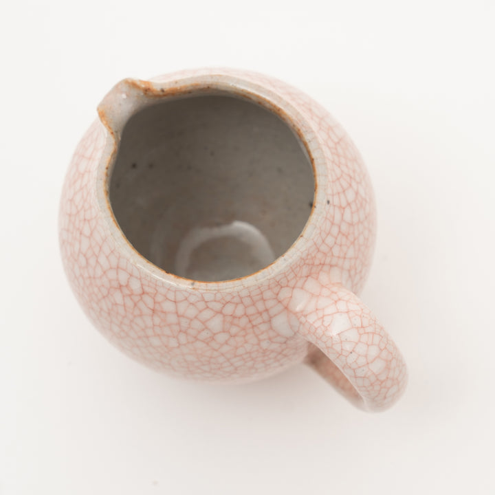 Overhead view of the Zohogama Aka Kannyu mini creamer, showing the detail of the cracked red glaze and the spout.