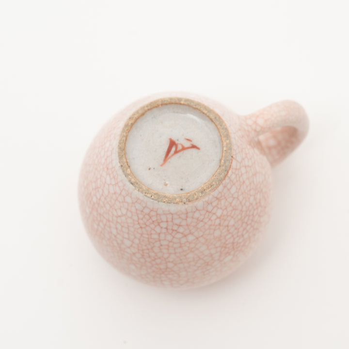 Bottom view of the Zohogama Aka Kannyu mini creamer, showing the kiln mark and the unique cracked glaze pattern.