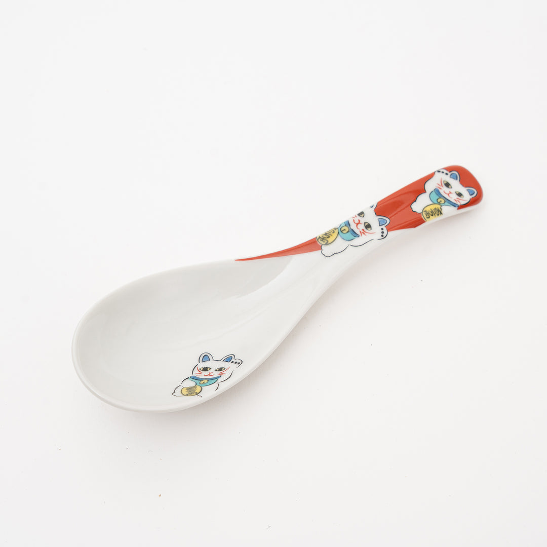 Kutani Ware Maneki-Neko ceramic spoon with a white base, red and white handle featuring two lucky cat illustrations, and a third lucky cat decorated on the spoon bowl.