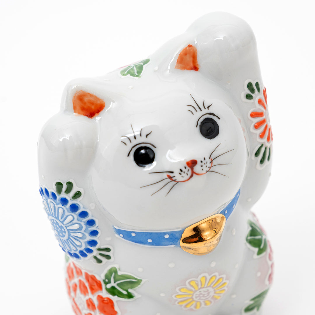 Ceramic cat-shaped figurine with colorful patterns on a white background