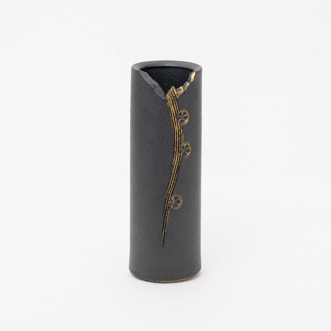 Black cylindrical vase with gold decorative elements on a white background