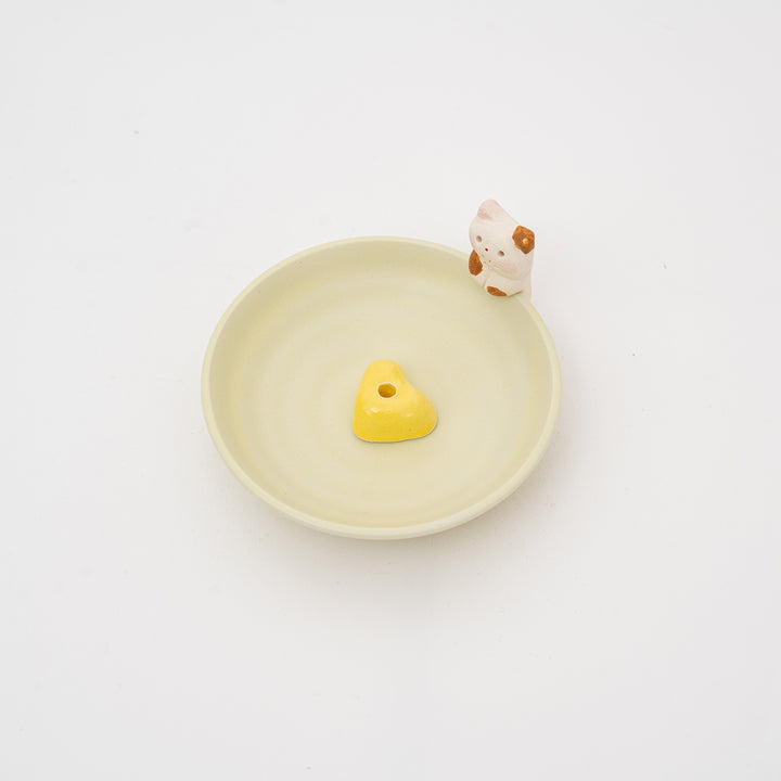 Yellow heart-shaped incense holder with a cat design