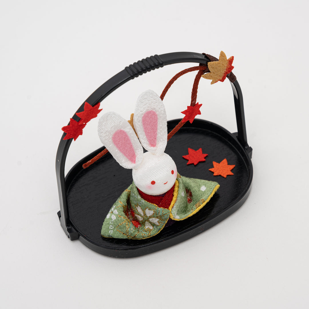 side view of kawaii Japanese rabbit figurine showing detailed kimono fabric and autumn maple leaf decorations
