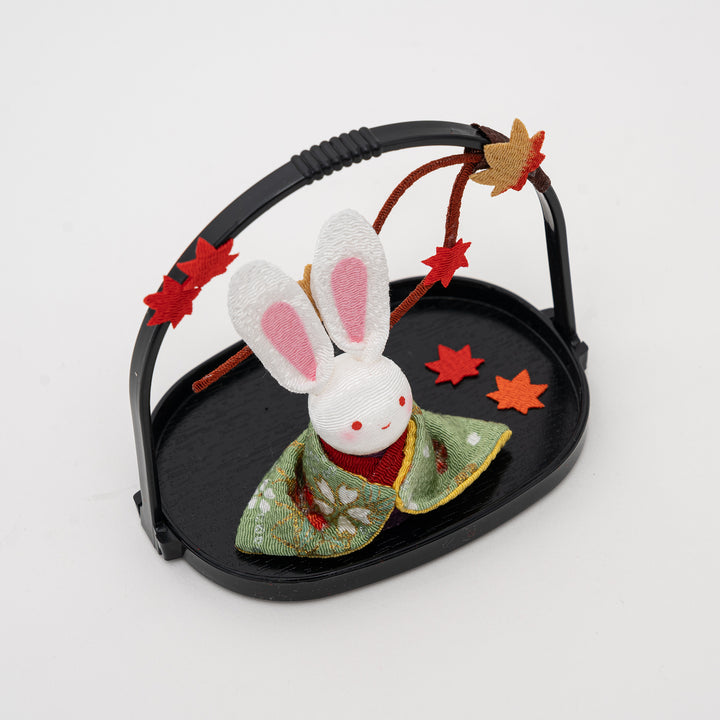 side view of kawaii Japanese rabbit figurine showing detailed kimono fabric and autumn maple leaf decorations