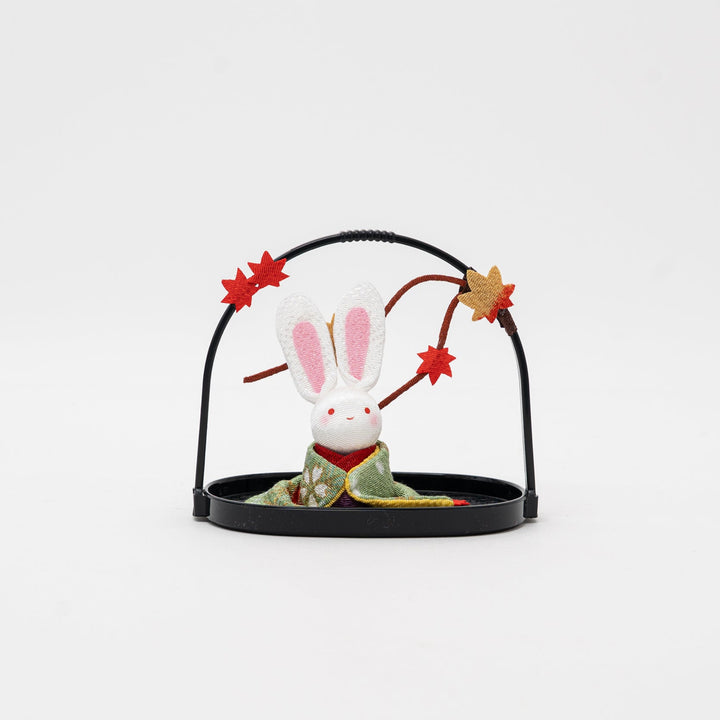 Kyoto Ryukodo handmade cute Japanese rabbit figurine in a green kimono, sitting in a black resin basket with red maple leaf accents.