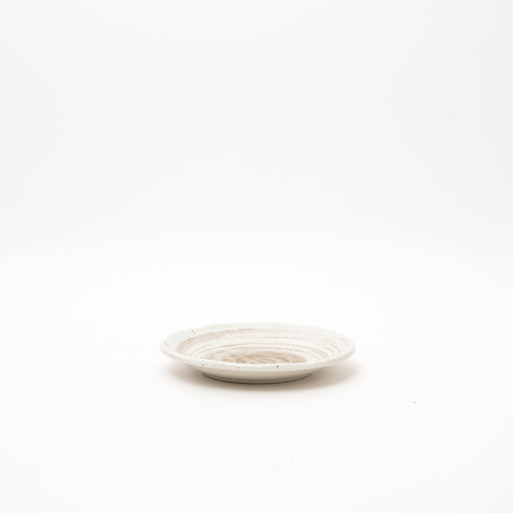 Japanese round ceramic sauce dish with spiral pattern glaze in cream and brown tones