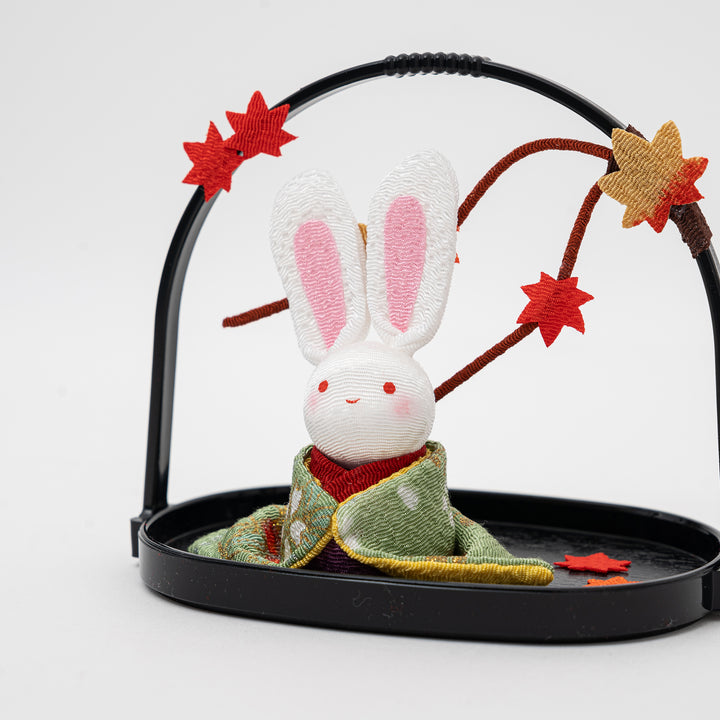 Ryukodo rayon crepe kawaii rabbit figurine in a traditional kimono, with pink ears and autumn maple leaves, showcasing its handmade detail.