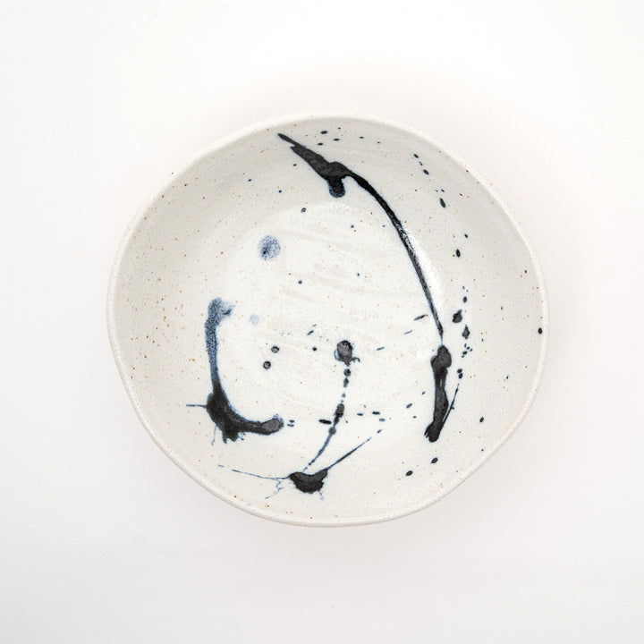 Close-up of traditional Kuresu-nagashi flowing blue glaze technique on handcrafted Japanese ceramic bowl