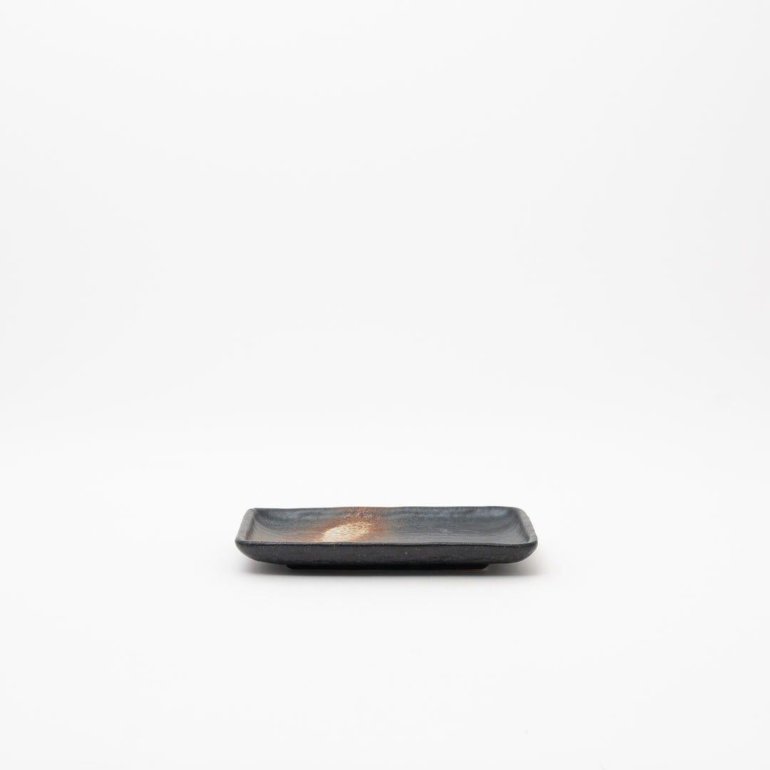 Handmade Japanese Seto Ware black rectangular ceramic plate with a rustic brown and speckled ash glaze pattern