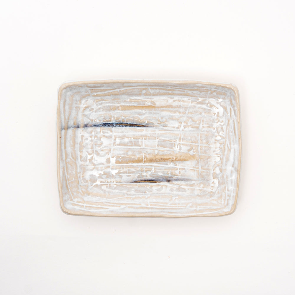 Close-up of Sazanami wave texture on handcrafted Japanese ceramic plate showing rippling surface detail