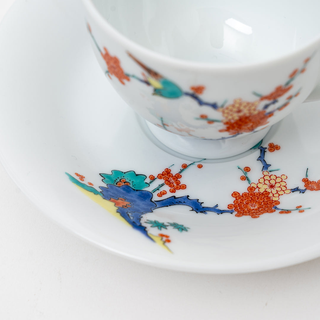 Arita Ware cup and saucer set from Japan, highlighting the colorful hand-painted plum branches and a bird