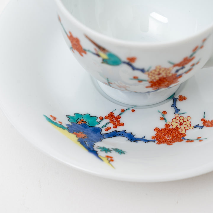 Arita Ware cup and saucer set from Japan, highlighting the colorful hand-painted plum branches and a bird