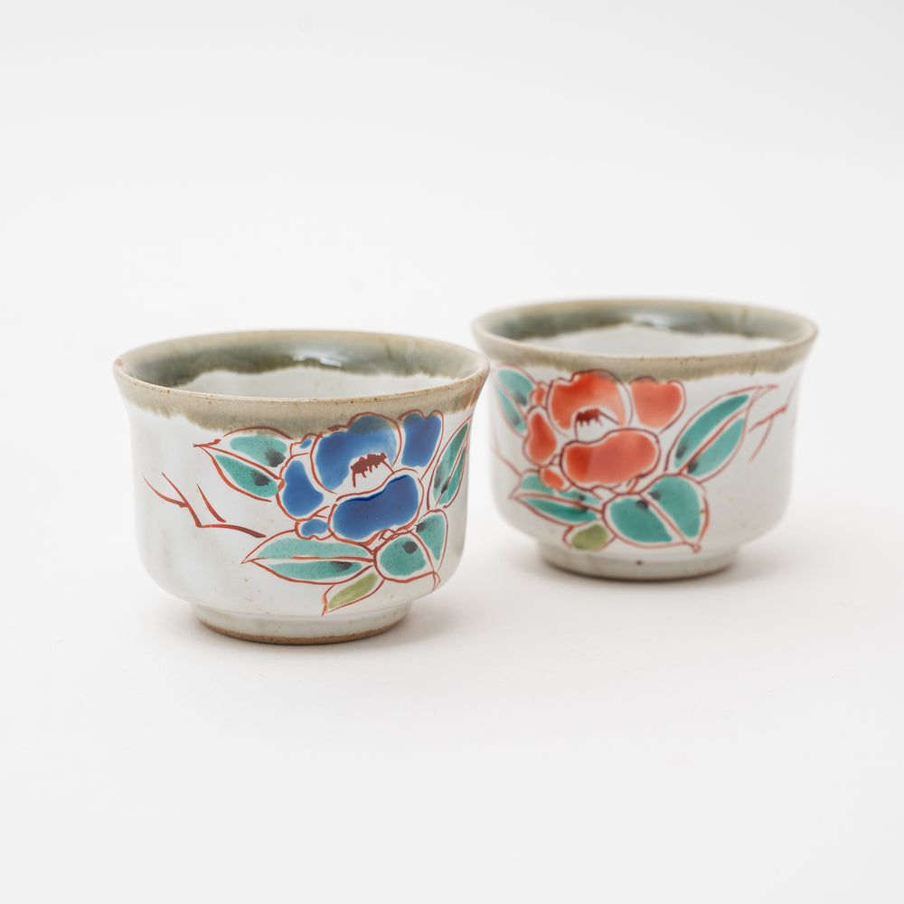 Close-up of a hand-painted Kutani Ware ochoko cup with a blue and red floral motif.