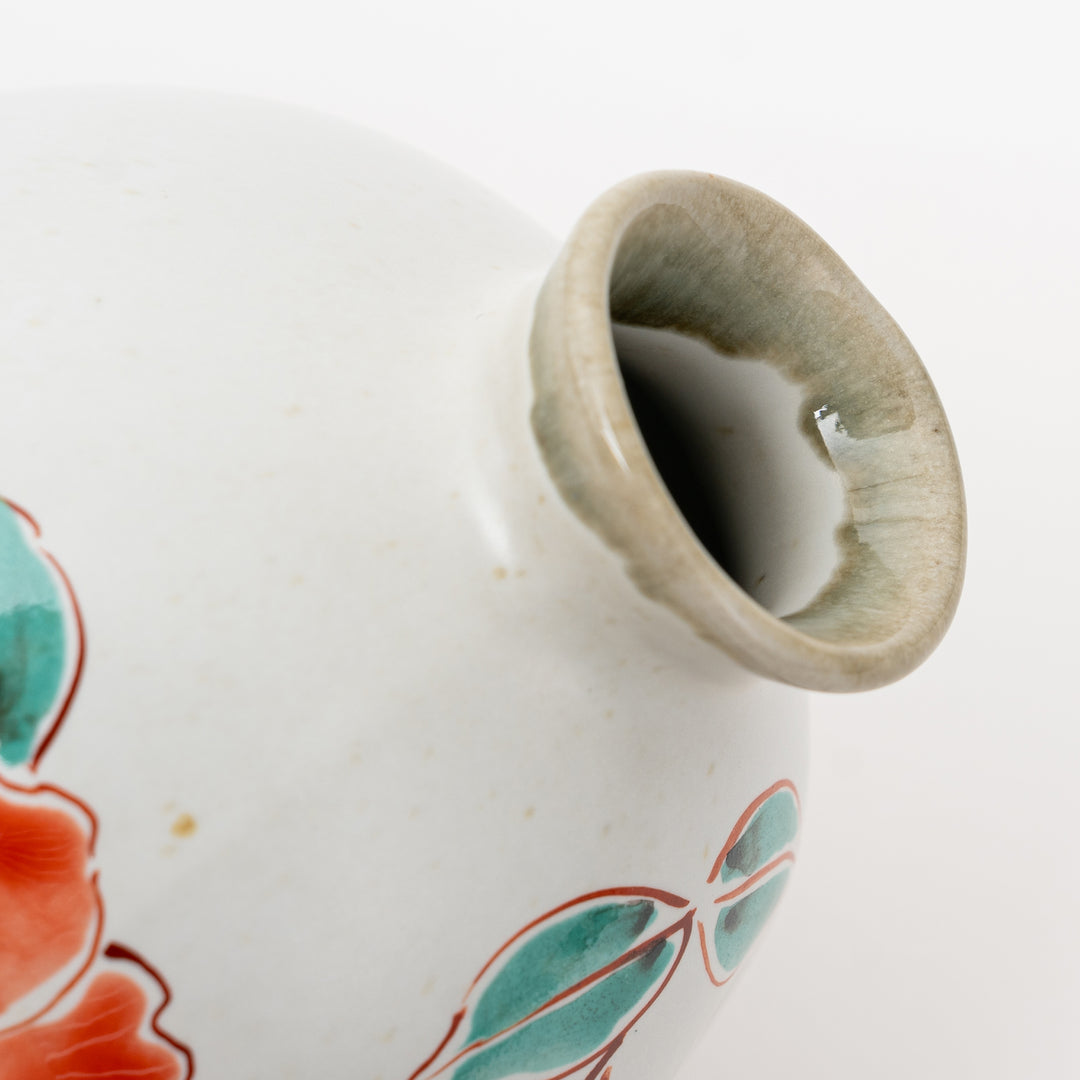 Detailed view of the spout of a hand-painted Kutani Ware sake flask.