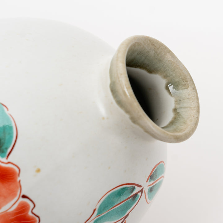 Detailed view of the spout of a hand-painted Kutani Ware sake flask.