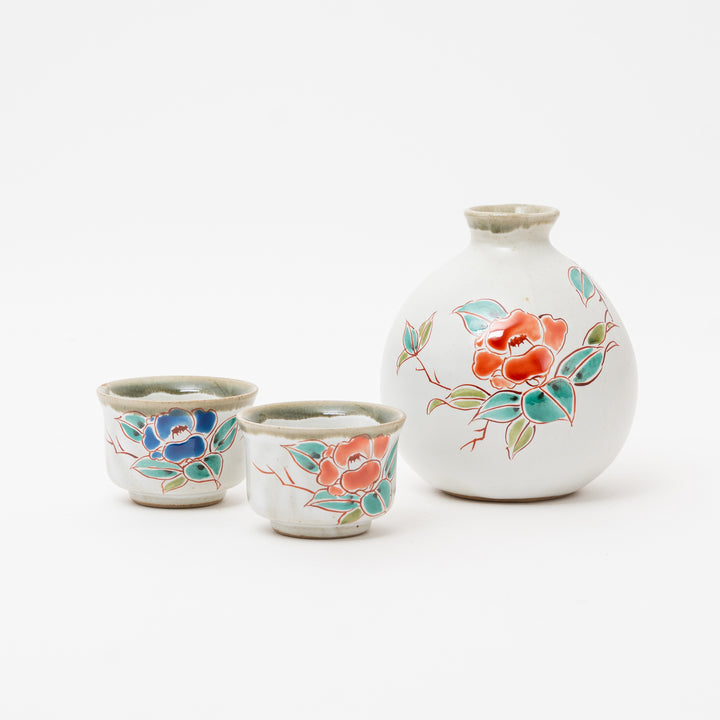 Hand-painted Kutani Ware sake set featuring a tokkuri and two ochoko cups with a vibrant floral design.