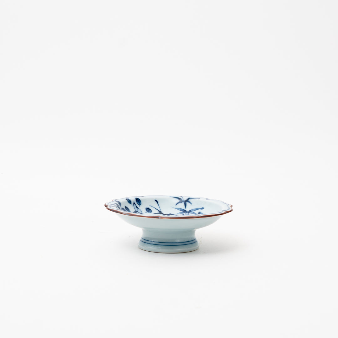 Hasami Ware "Manyo Ichikanjin" high-stand small dish with a detailed blue and red pattern and golden accents.