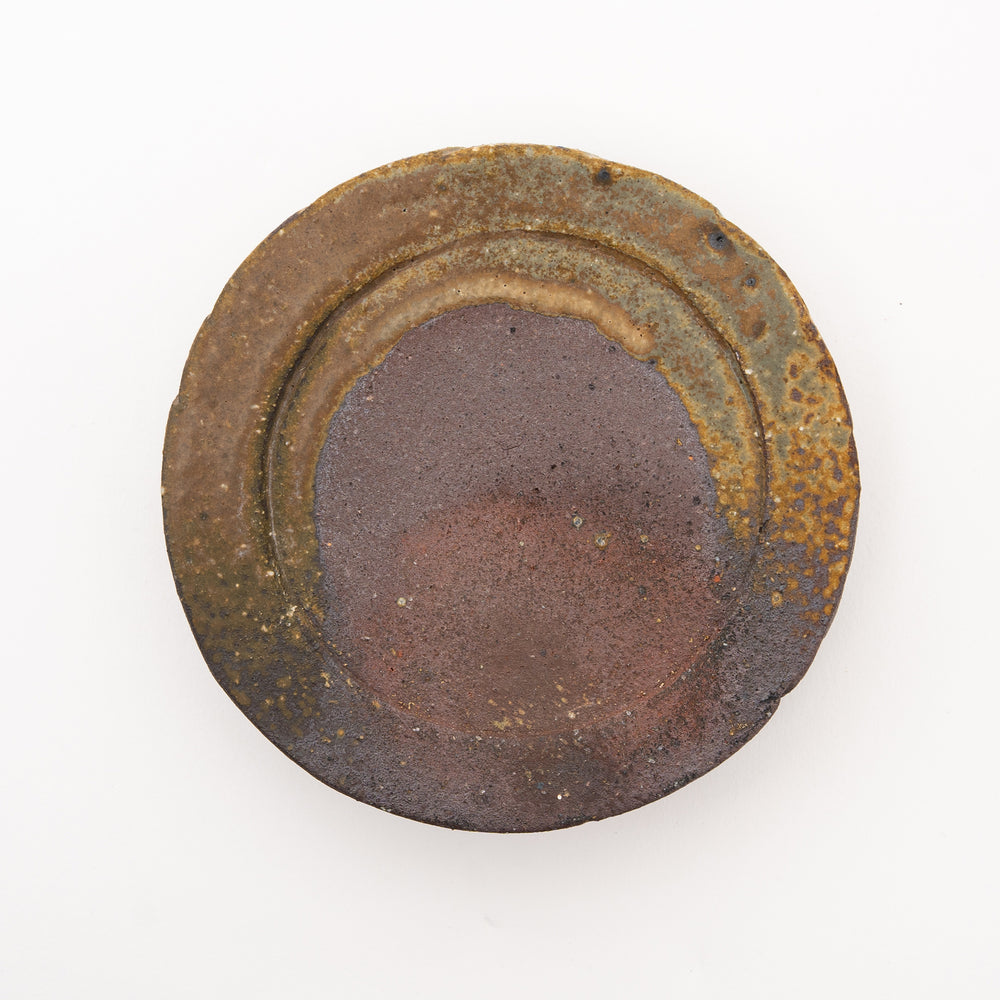 An overhead view of a handmade Japanese Shigaraki ware Taiko Zara plate, showcasing its wabi-sabi aesthetic and rustic, earthy glaze.
