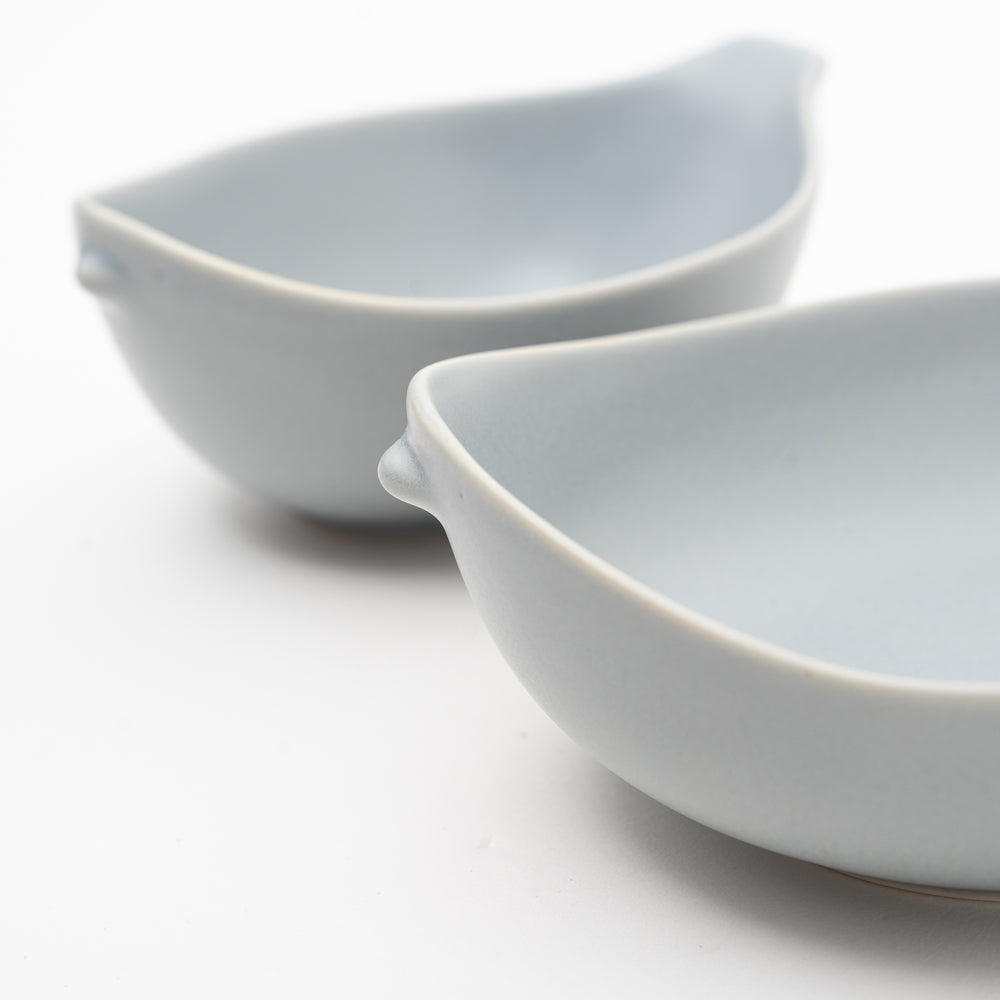 Close-up of smooth matte porcelain Japanese bowl with bird silhouette design