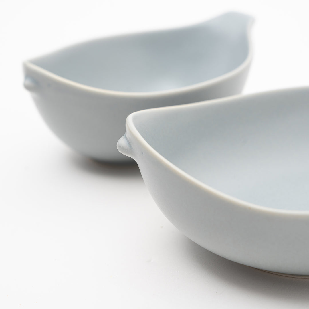 Close-up of smooth matte porcelain Japanese bowl with bird silhouette design