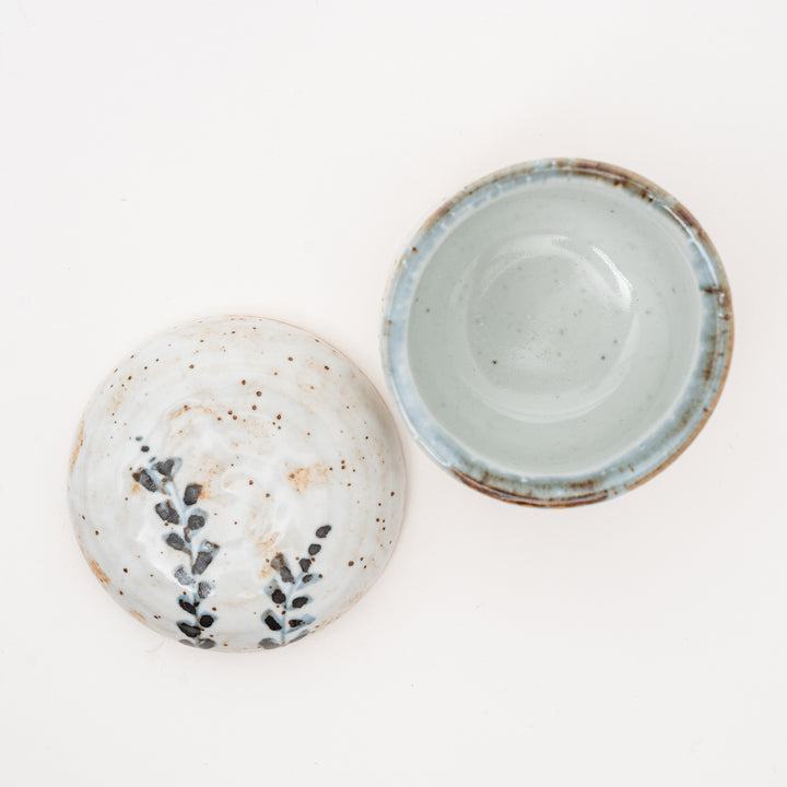 Overhead view of a Shino Tataki Ashimushi Chawanmushi bowl with its lid removed, showing the pale blue-grey interior and the natural, speckled Shino glaze
