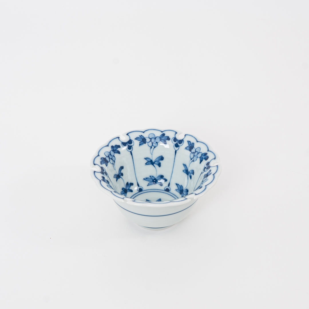 Perspective view of a blue and white Hasami ware porcelain dish for dipping sauces and appetizers, featuring traditional Japanese rabbit and flower motifs.