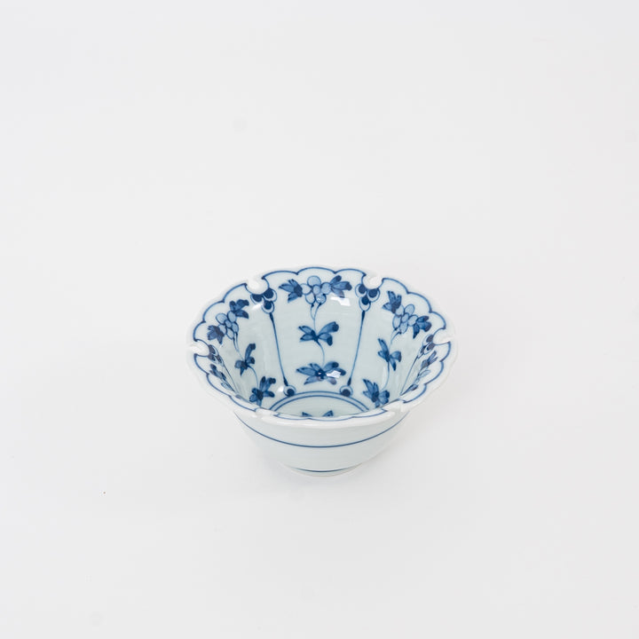 Perspective view of a blue and white Hasami ware porcelain dish for dipping sauces and appetizers, featuring traditional Japanese rabbit and flower motifs.