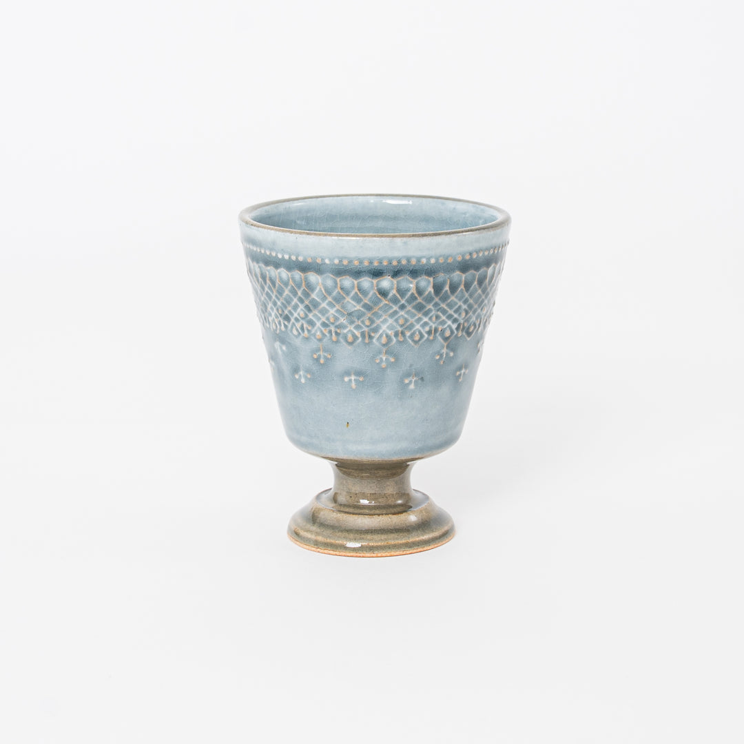 Handcrafted Japanese Mashiko-yaki ceramic footed cup with blue-grey crackle glaze and embossed lattice pattern