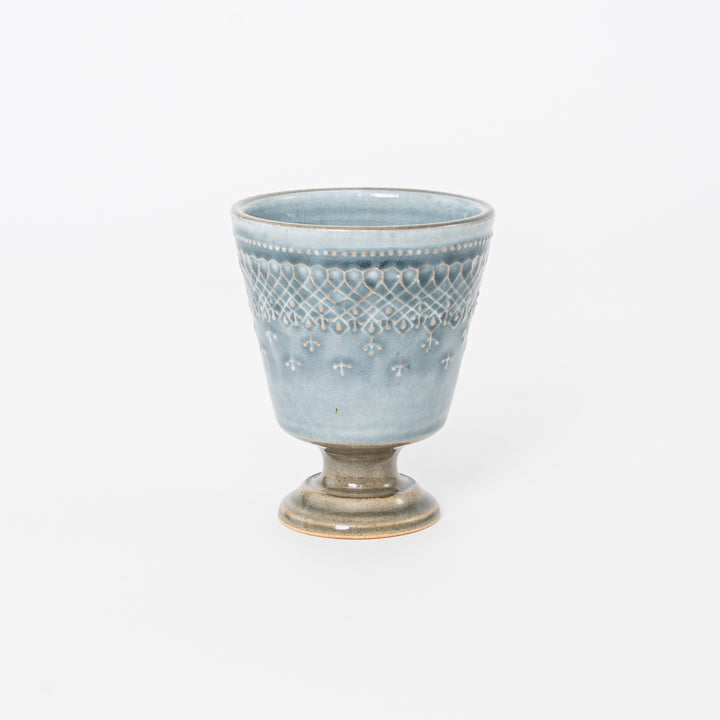 Handcrafted Japanese Mashiko-yaki ceramic footed cup with blue-grey crackle glaze and embossed lattice pattern