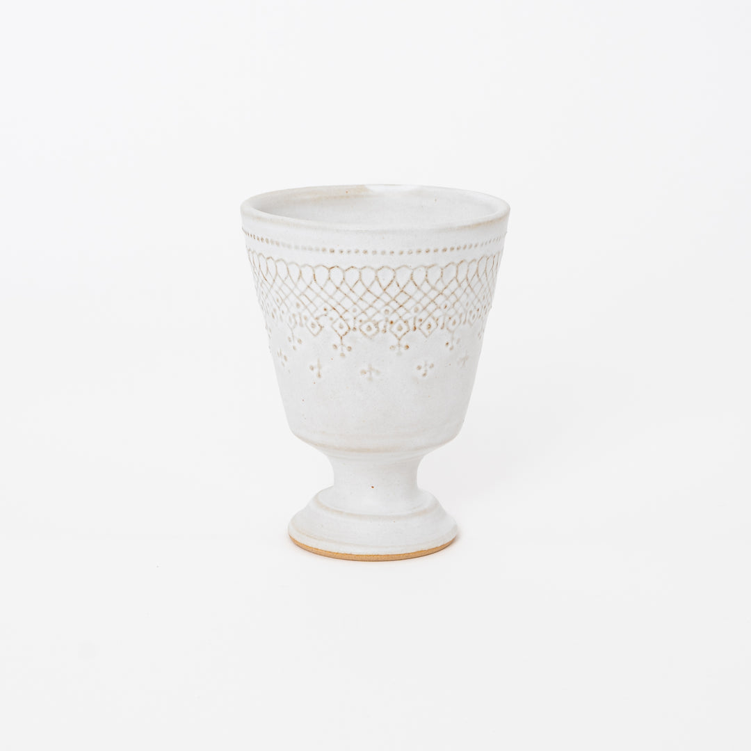 Handcrafted Japanese Mashiko-yaki ceramic footed cup in matte cream white with embossed lattice pattern