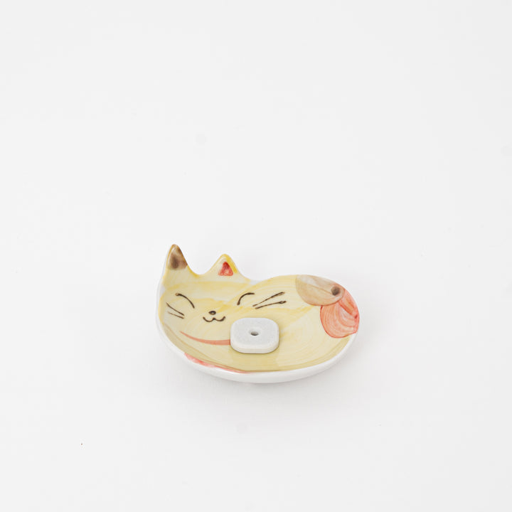 Ceramic cat-shaped container with a white background