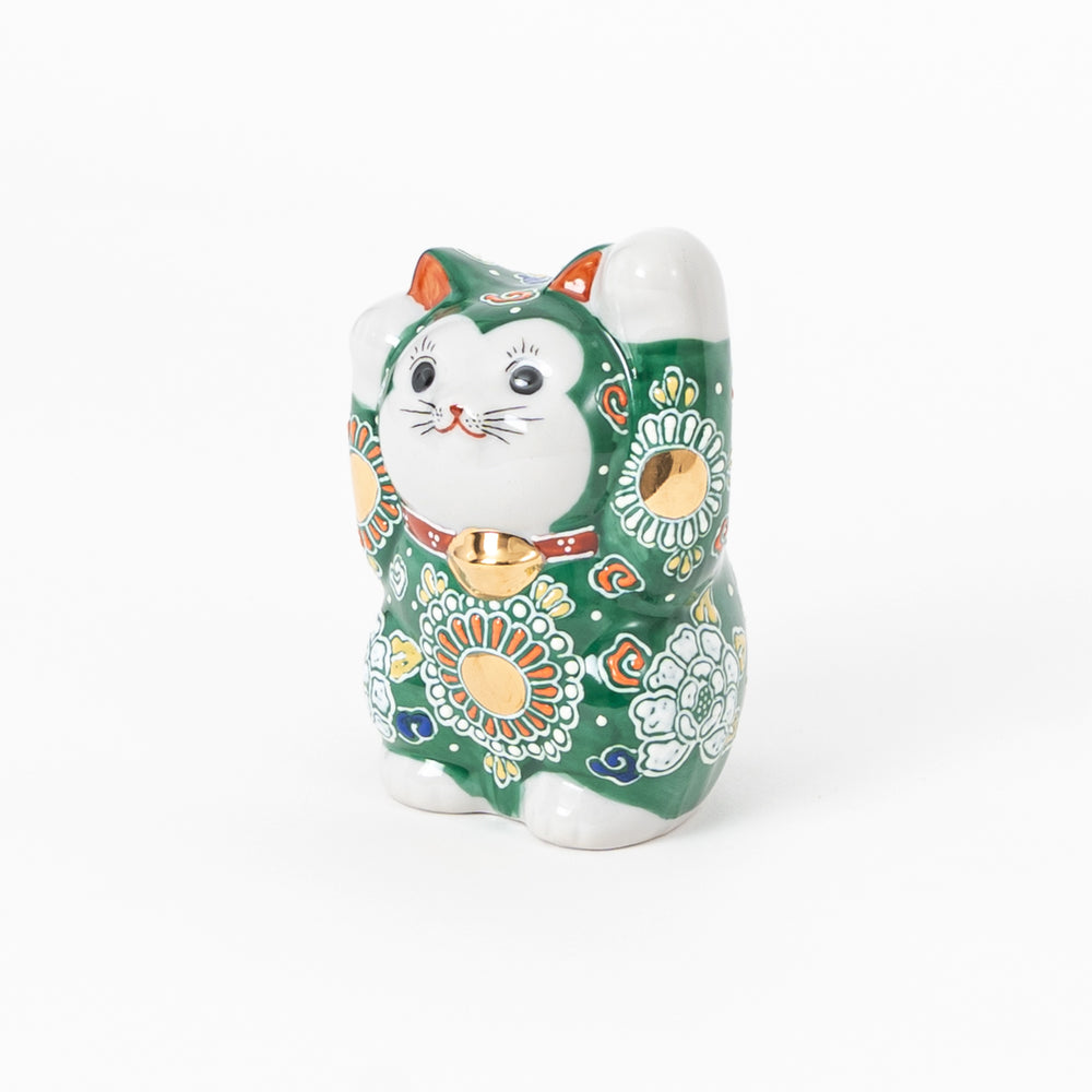 Hand-painted Kutani ware lucky cat figurine with green overglaze and traditional floral patterns