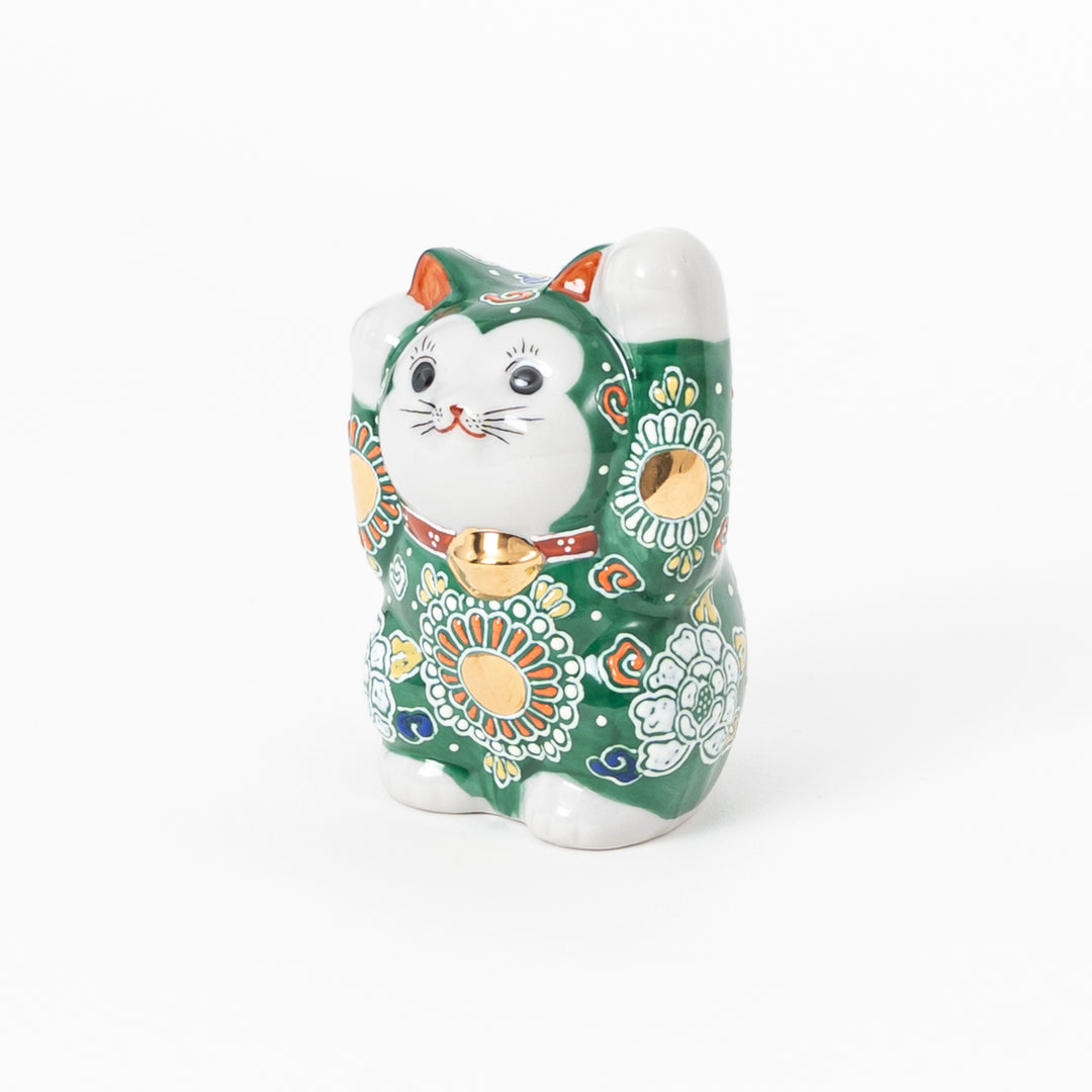 Hand-painted Kutani ware lucky cat figurine with green overglaze and traditional floral patterns