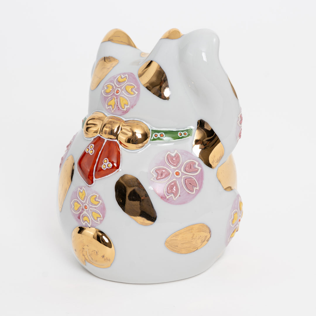 Rear view of Kutani porcelain cat showing cherry blossom patterns and artisan hallmark.