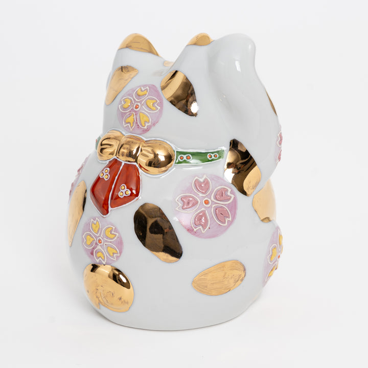 Rear view of Kutani porcelain cat showing cherry blossom patterns and artisan hallmark.