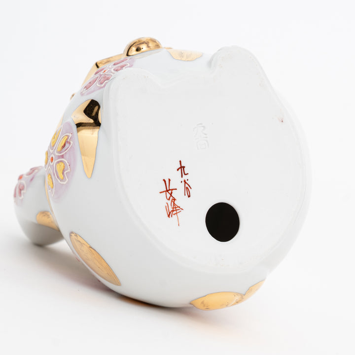 Rear view of Kutani porcelain cat showing cherry blossom patterns and artisan hallmark.