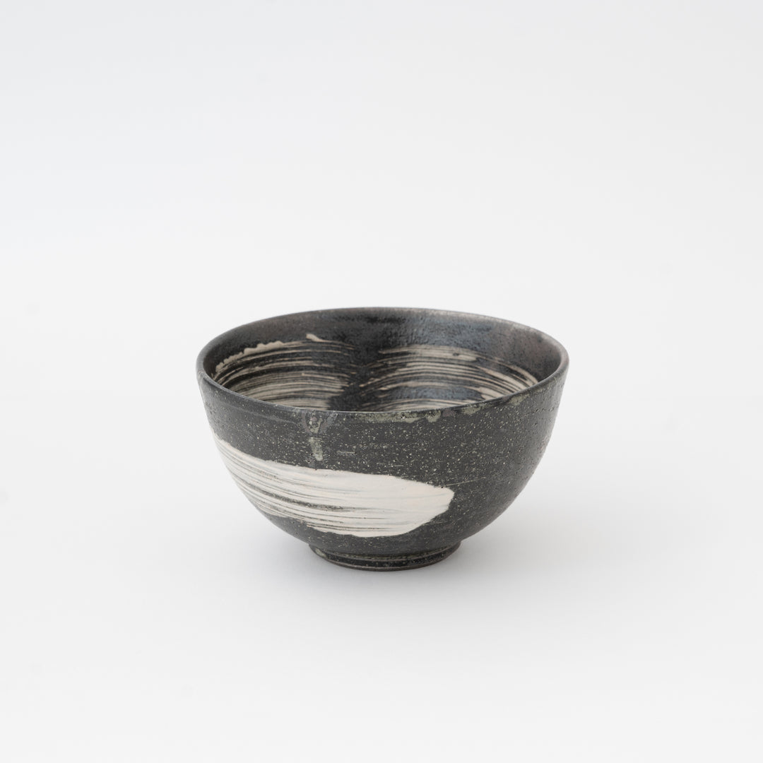 Black ceramic bowl with white interior on a white background