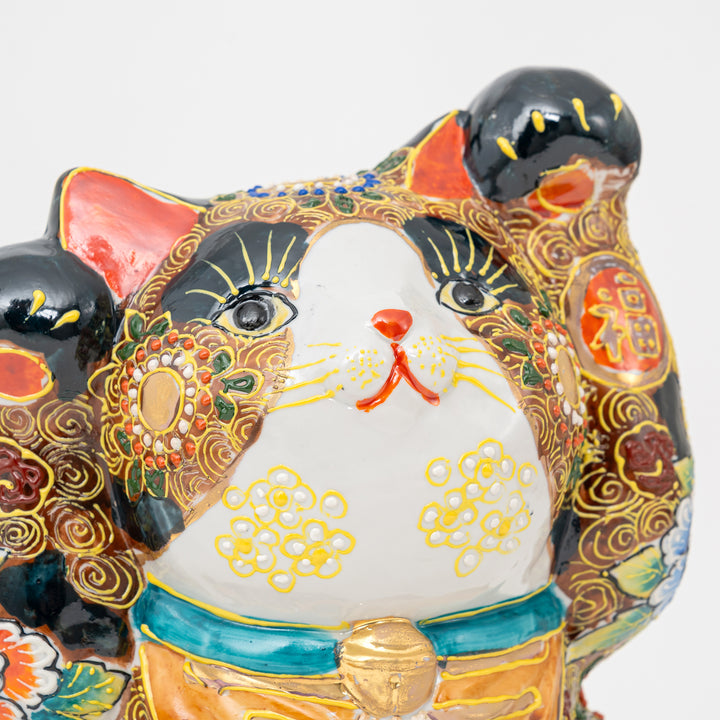 Decorative Japanese Lucky cat figurine with intricate designs and colors on a white background