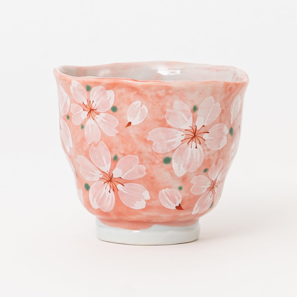 Pink Japanese ceramic yunomi tea cup featuring hand-painted sakura blossoms