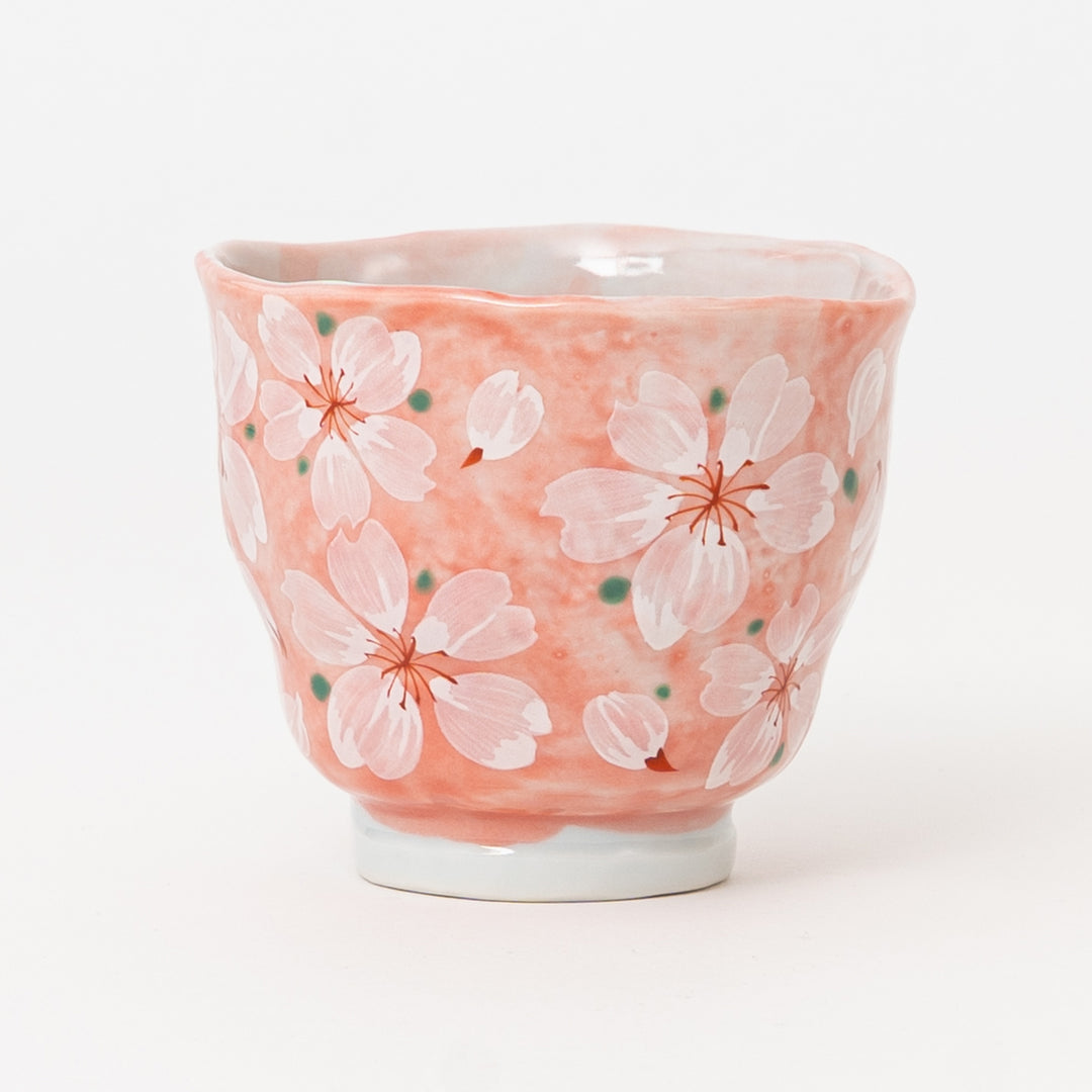 Pink Japanese ceramic yunomi tea cup featuring hand-painted sakura blossoms