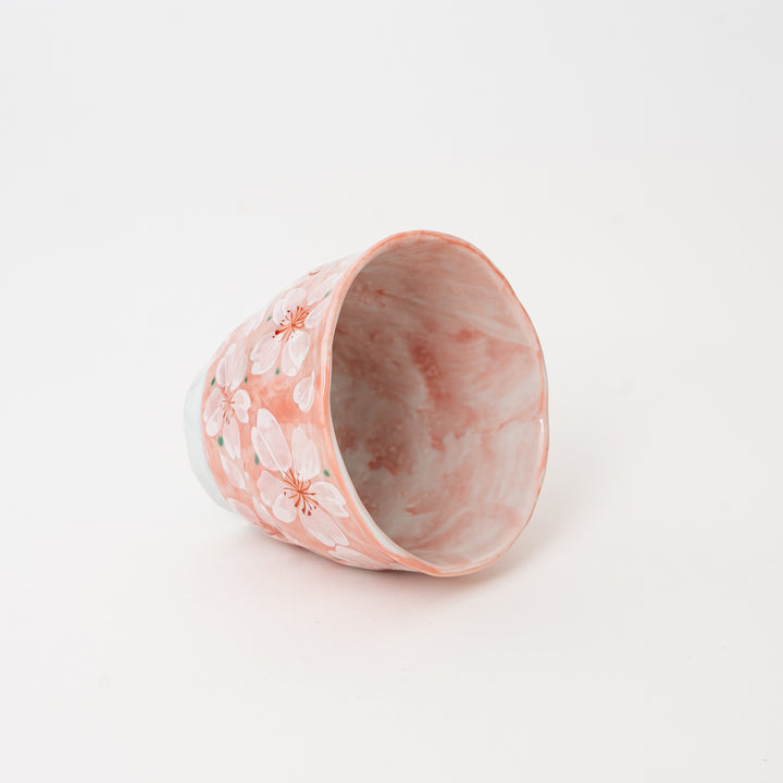 Japanese handcrafted ceramic tea cup decorated with delicate sakura flowers