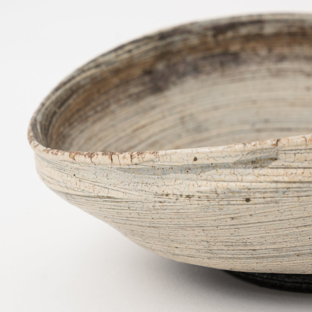 Close-up of the irregular rim and textured glaze on a Shigaraki ceramic bowl