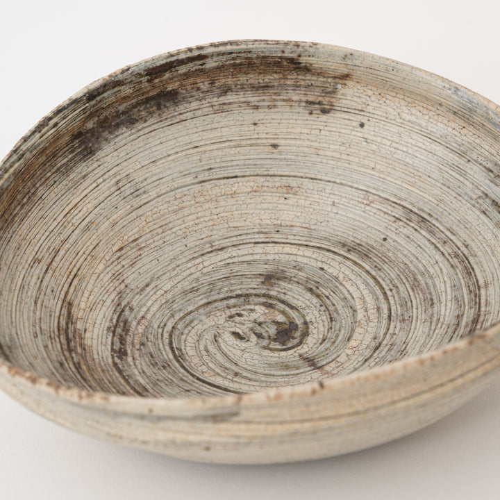 Angled view of an oval Shigaraki bowl with a sculptural asymmetrical form