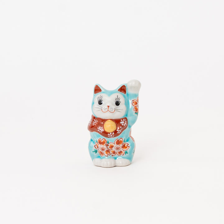 Hand-painted Japanese Kutani Ware Lucky Cat Maneki Neko in light blue with red and white cherry blossom patterns, made in Japan.