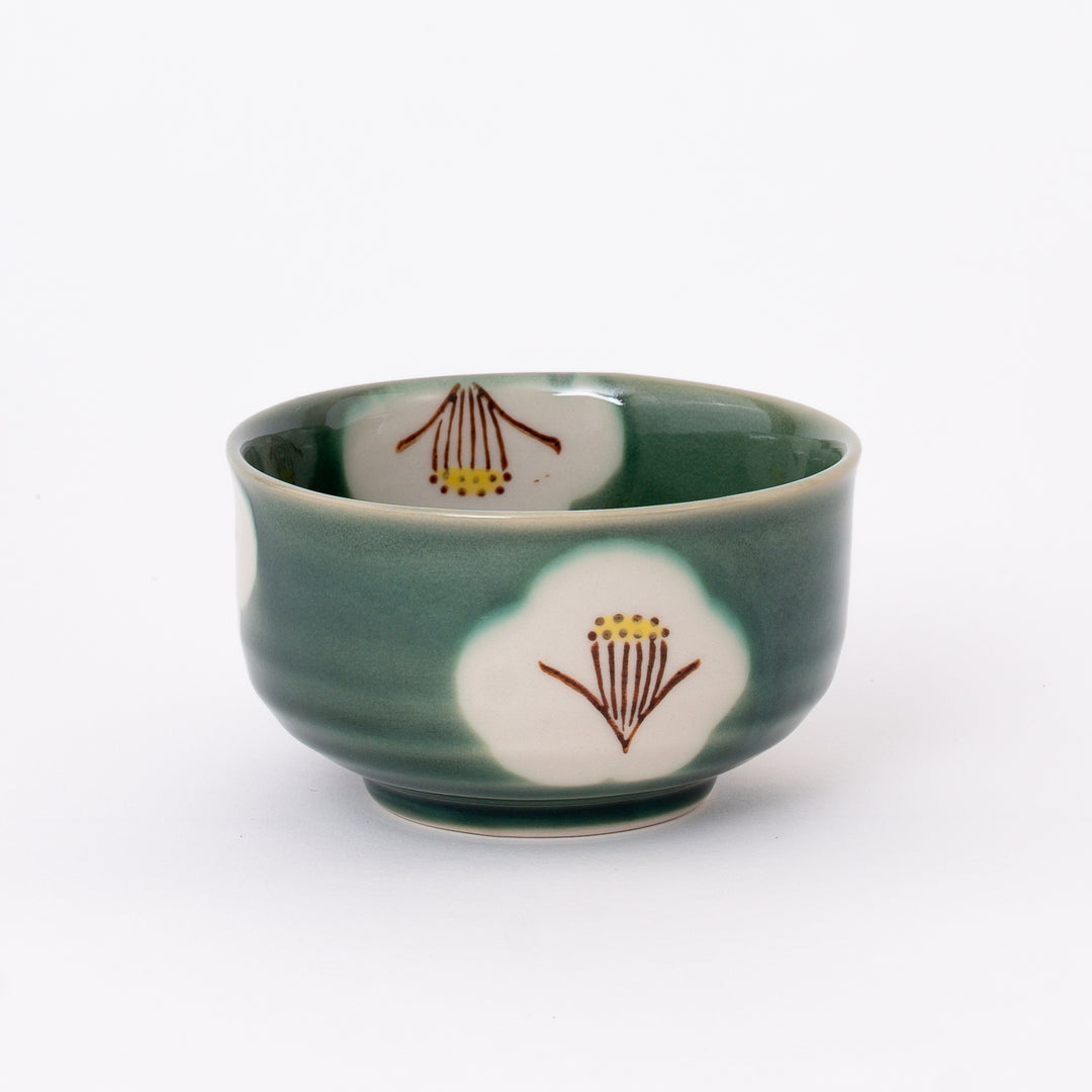 Handcrafted Japanese Seto Ware Oribe Camellia Matcha Bowl with a hand-painted white camellia design and soft green glaze.