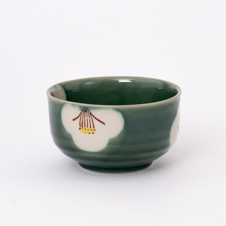 Front view of a Japanese Seto Ware Oribe Matcha Bowl featuring a hand-painted camellia flower on a traditional green glaze.