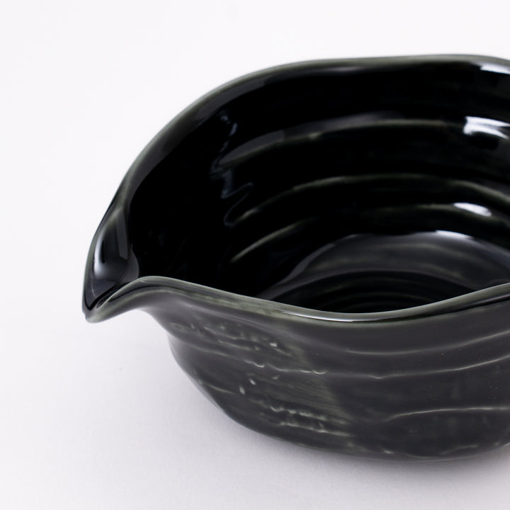 Close-up of the rich Oribe green glaze on a handcrafted Japanese Mino Ware matcha bowl.